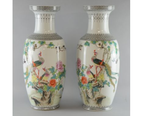 Pair of 20th century Chinese famille rose porcelain vases decorated with birds amongst flowering shrubs and rockery, with cal