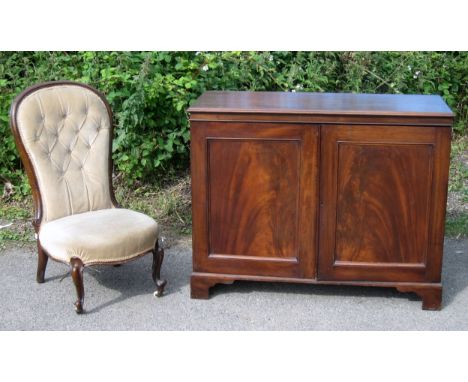 Mahogany two door cabinet and a mahogany framed spoon button back upholstered nursing chair