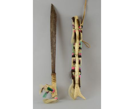 Borneo Dayak parang Ilang with carved bone handle and angled blade in reed scabbard with bone carving, decorated with multi c