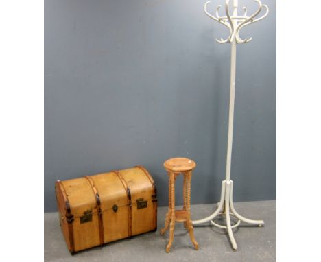 Dome top trunk with a carved plant stand and bentwood coat stand