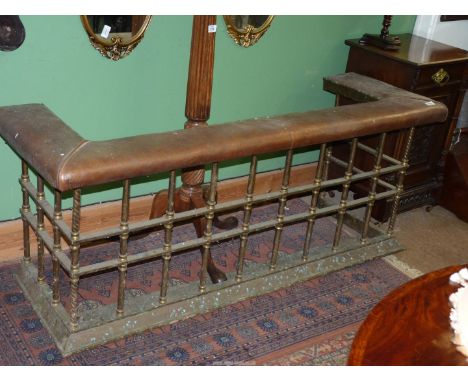 A most substantial Brass Fireguard/Seat having sixteen turned and twist decorated multiple supports and a leather upholstered