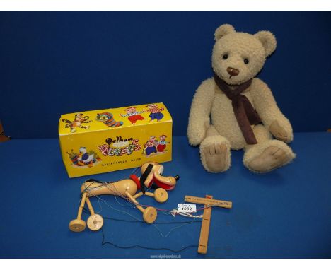 A Pluto (Walt Disney character) Pelham Puppet and a beige "Charlie Bear" with brown scarf.