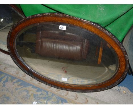 An oval Oak framed, bevel plated Wall Mirror, 31 1/2" x 22".