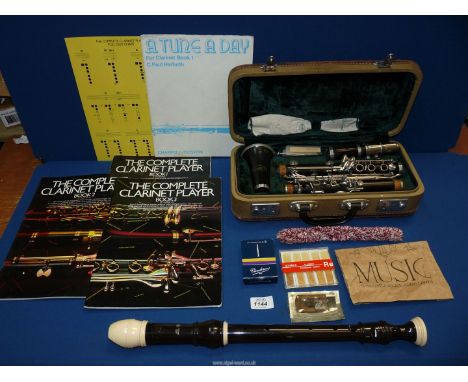 A boxed Corton clarinet with accessories, three music books and an Allios recorder.