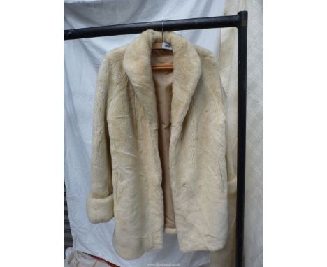 A ladies 3/4 length cream faux fur Jacket by Astraka, size 14.