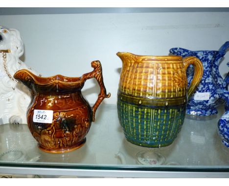 A 19th c. English Majolica Jug in raised weave and flower pattern 7" tall, plus an Arthur Wood treacle glazed jug with leopar