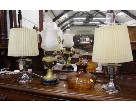 Two Aladdin paraffin lamps with shades and chimneys, converted Victorian oil lamp with shade and chimney and spare orange gla