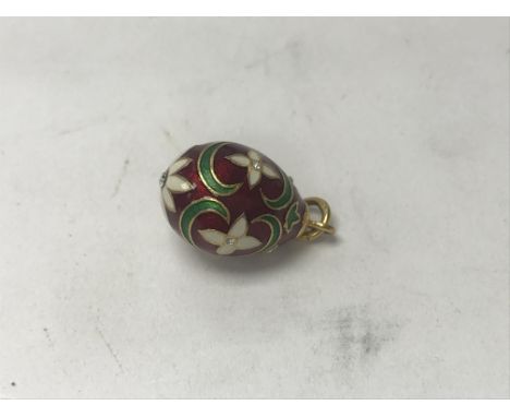 A high carat gold and enamel egg pendant set with white stones, approx 2.80 grams.