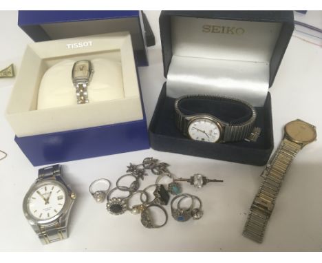 A quantity of silver rings an unmarked bar brooch a boxed ladies Tissot watch and other watches (a lot)