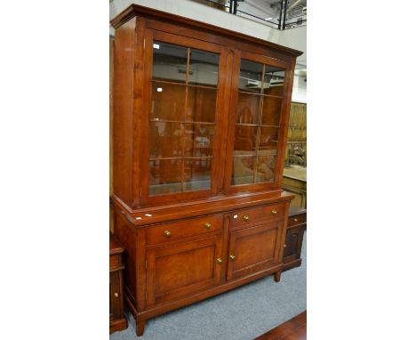 An R E H Kennedy Cherrywood Bookcase Model 4039, the upper section with two glazed doors enclosing adjustable shelves, the ba