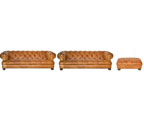 A Pair of Brown Leather Button Back Chesterfield Style Sofas, of recent date, retailed by John Lewis, raised on turned legs, 