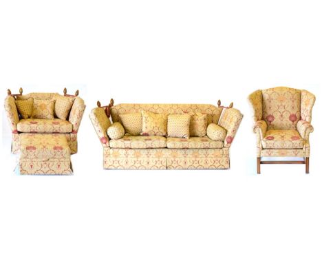 A Three Piece Knole Suite, of recent date, upholstered in gold and red pattern fabric, comprising three-seater sofa with drop