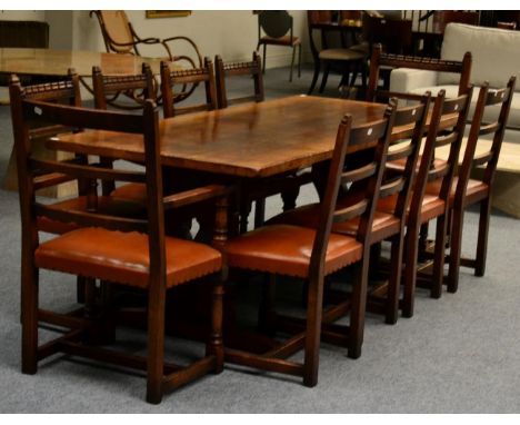 A Titchmarsh & Goodwin Oak Refectory Style Dining Table, the shaped end supports joined by a stretcher, raised on sledge base