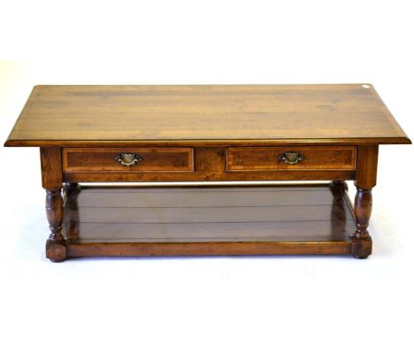 A Reproduction Oak and Crossbanded Coffee Table, of recent date, with two drawers above turned legs with block feet joined by