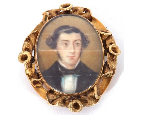 Antique miniature oval brooch, hand painted with head and shoulders portrait of a gentleman, in a decorative yellow mount, 50