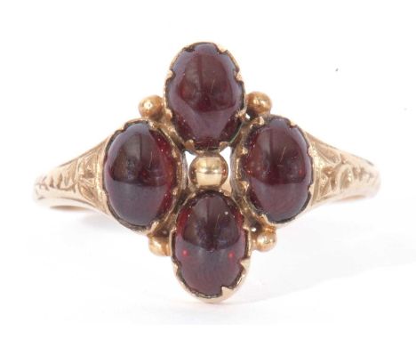 9ct gold and garnet set ring, the gold bead centre surrounded by four cabochon oval garnets, all in engraved settings, size Q