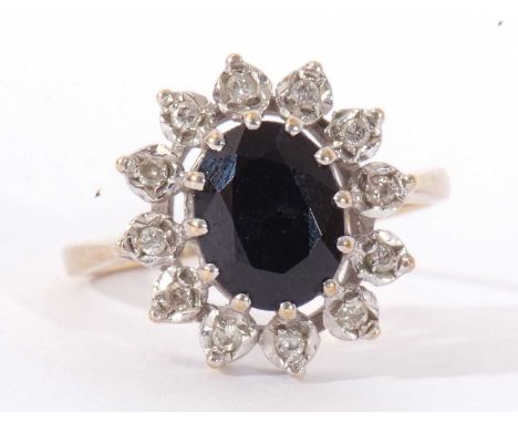 9ct gold sapphire and diamond cluster ring, the dark oval sapphire set within a small diamond surround, size N/O