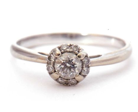 Modern diamond halo ring centring a round brilliant cut diamond surrounded by eight small diamonds, total wt 0.25ct approx, s