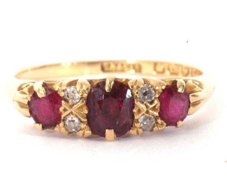 Victorian ruby and diamond ring featuring three graduated oval cushion cut rubies, highlighted between with four small diamon