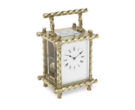A late 19th century French brass repeating carriage clockthe spiral twisted frame with rectangular enamel Roman dial with mat
