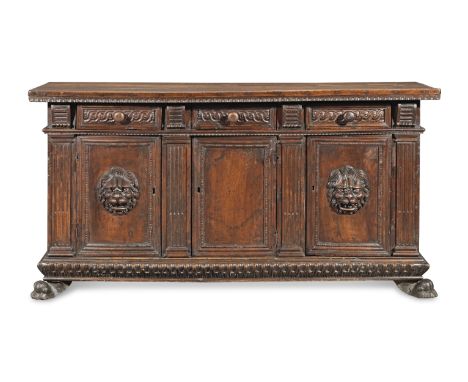 An Italian late 16th/early 17th century carved walnut credenzaprobably of Tuscan originThe rectangular top with a fluted edge