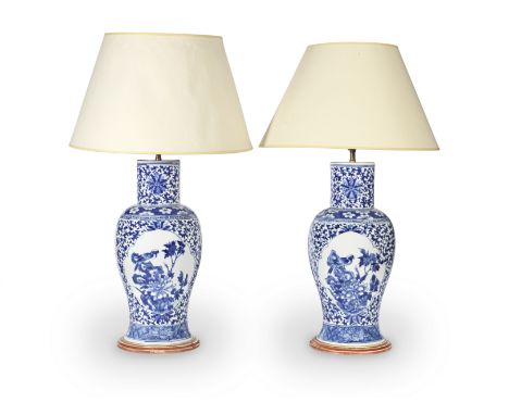 A pair of late 19th / early 20th century Chinese blue and white porcelain vases adapted as lamp bases with shadesin the Kangx