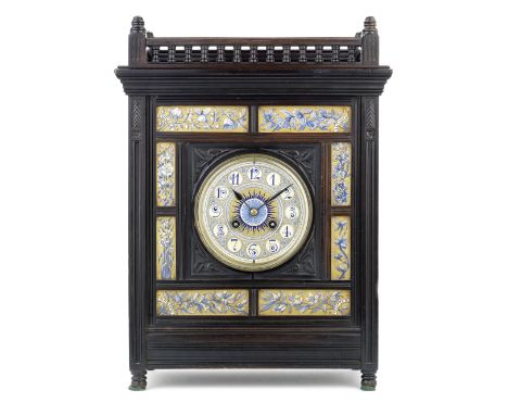 A late 19th century Aesthetic style ebonised and blue and gilt enamelled ceramic tile mounted mantel clockthe rectangular ree