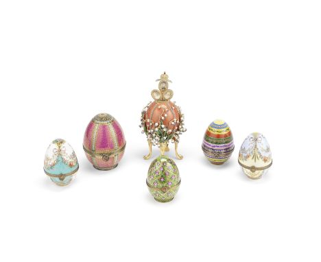 A collection of six Faberge and Russian style decorative enamel and porcelain eggscomprising a enamel copy of the Lilies of t