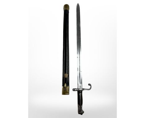 An Italian M 1870 Vetterli sword bayonet with brass-mounted leather scabbard, 51cm blade stamped' Torino', scabbard stamped '
