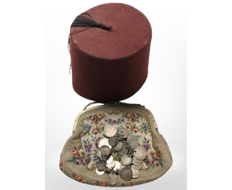 A silver coin bracelet, a lady's gilt metal mounted tapestry evening purse and a fez. 