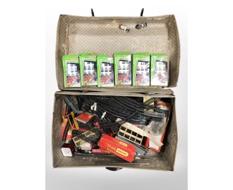 A vintage suitcase containing Subbuteo football teams, Tri-ang Hornby railway track, etc. 