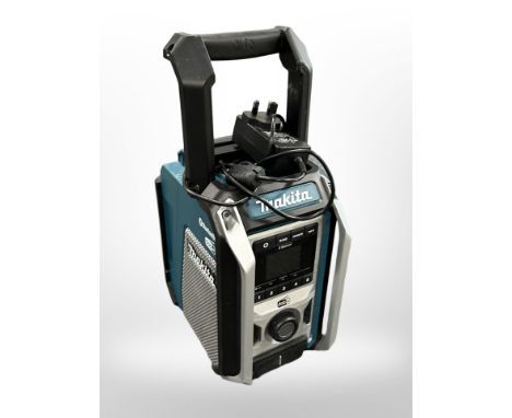 A Makita DMR115 bluetooth portable radio speaker, with charger. 
