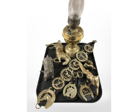 A brass oil lamp, a quantity of horse brasses, animal figures, etc. 