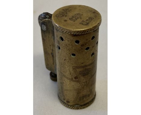 A German WWI style trench art lighter with engraved detail.  Approx. 4.5cm tall.