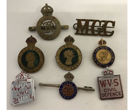 A collection of vintage military badges to include Royal Horse Guards and Women's Land army. Lot includes pin badges (to incl