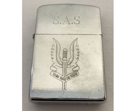 A modern windproof lighter with engraved S.A.S. "Who Dares Wins" logo. In as new, unused condition. 