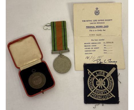 WWII 1939-45 Defence medal with ribbon, together with a boxed Royal Life Saving Society medal. Defence medal complete with or