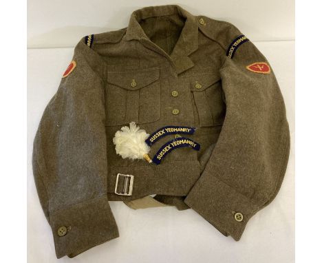 A 1960 British Army jacket with Sussex Yeomanry badges to arms and shoulders. Together with 2 cloth badges and a white feathe