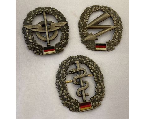 3 modern BRD German army beret badges. Logistics QM troops, Medical troops and Signal Corps.  