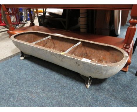 AN OVAL SHAPED CAST METAL TROUGH