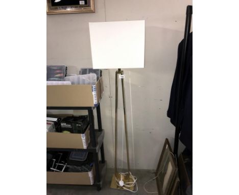 An ornate brass floor standing standard lamp