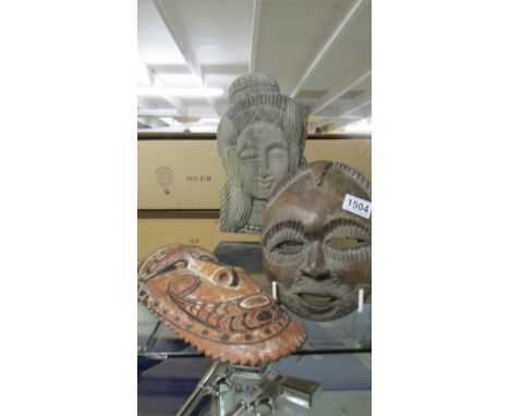 Two wooden wall masks and another wooden item.