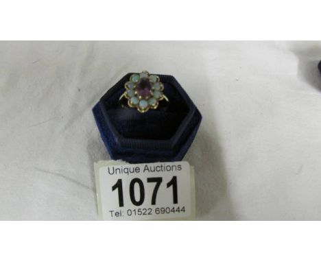 An opal and amethyst set cluster ring in 9ct gold, size K.