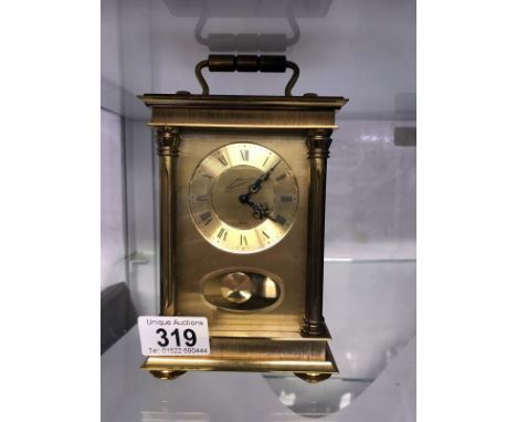 A heavy brass carriage clock stricking on bell. Made in Germany