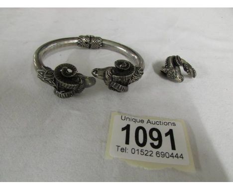 A silver Ram's head bangle with matching ring, 57.6 grams.
