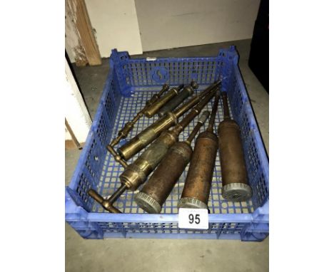 A quantity of vintage grease guns including some brass examples