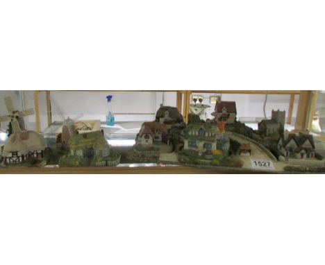 Ten model cottages including Royal Doulton and a cottage base.