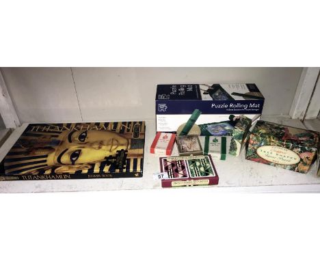 A Tutankhamun 4 x 96 piece jigsaw as a book, jigsaw rolling mat, playing cards and 1 other jigsaw