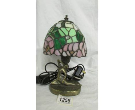 An art deco style white metal table lamp with leaded glass shade.