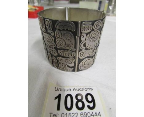 A Mexican silver bangle with safety chain, 103.9 grams.